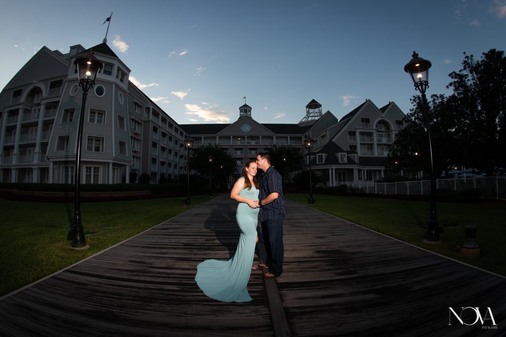 Happy couple at Disney’s Beach Club Resort for their sunset maternity photos.
