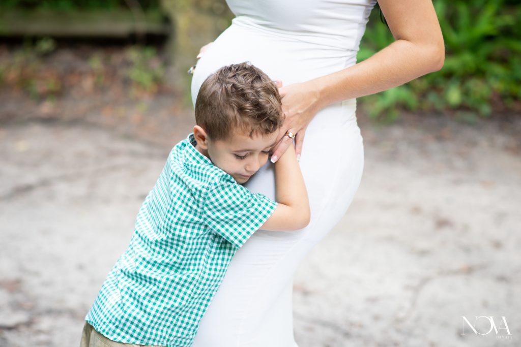 Son hugging mom’s belly during their Kelly Park maternity session.