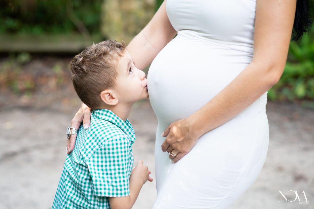 Son kissing mom’s belly during their Kelly Park maternity session.