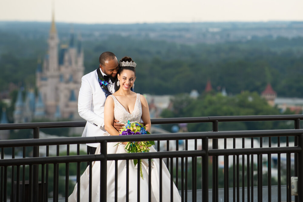 Married couple standing on a bridge at Disney World