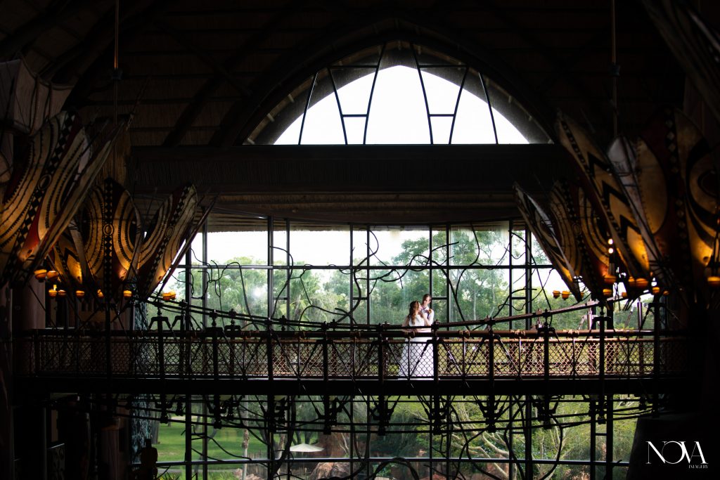Bride and groom standing on a bridge at Animal Kingdom Lodge for an Instagram worthy photo.