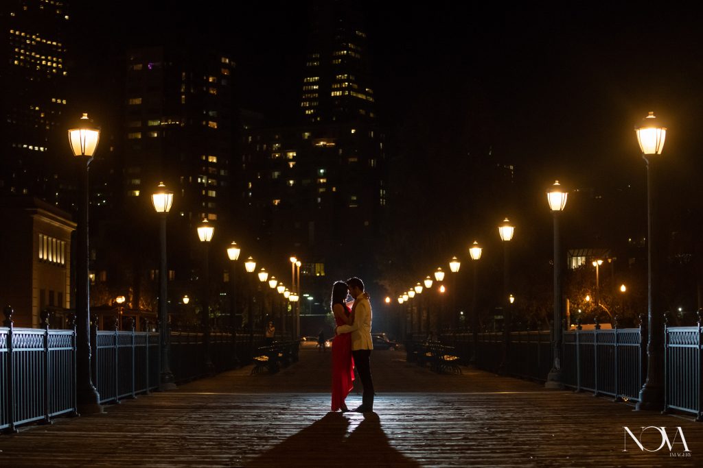 Romantic couple’s portrait in nighttime San Francisco engagement session.