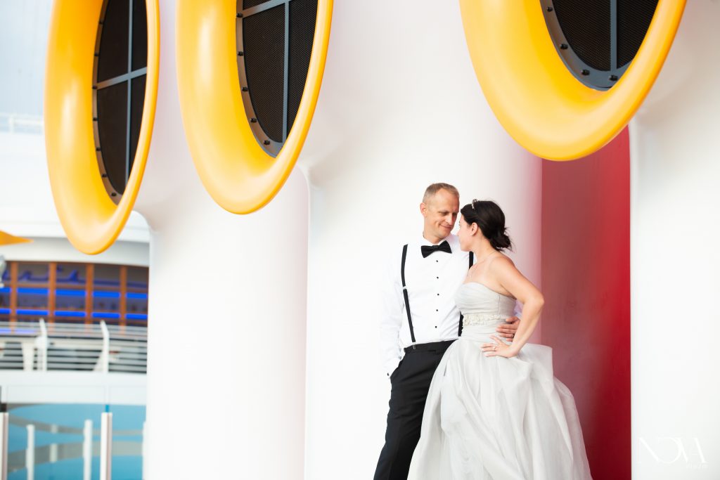 Couple smiling at each other during their Disney cruise wedding photoshoot.