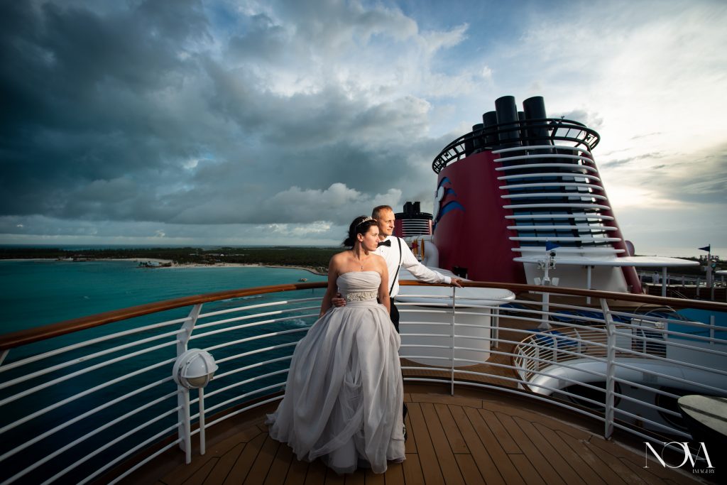 Couple gazing off into the distance during their Disney cruise wedding photoshoot.