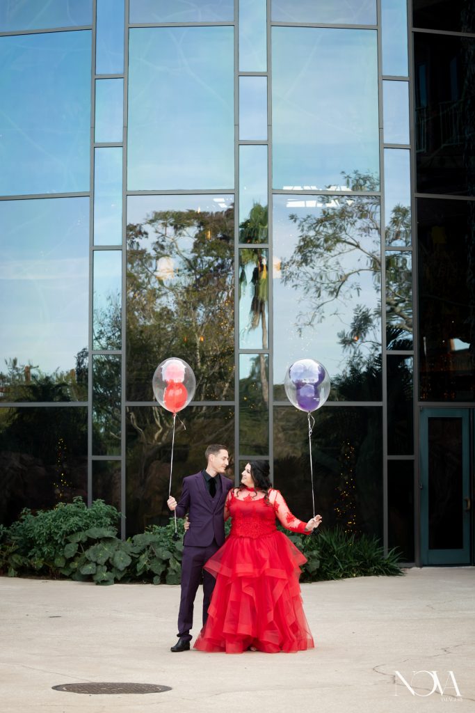 Couple holding mickey balloons during their Animal Kingdom Lodge photo session.