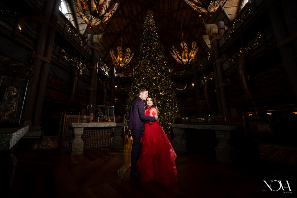 Couple embracing each other in front of staircase for their Animal Kingdom Lodge photo session.