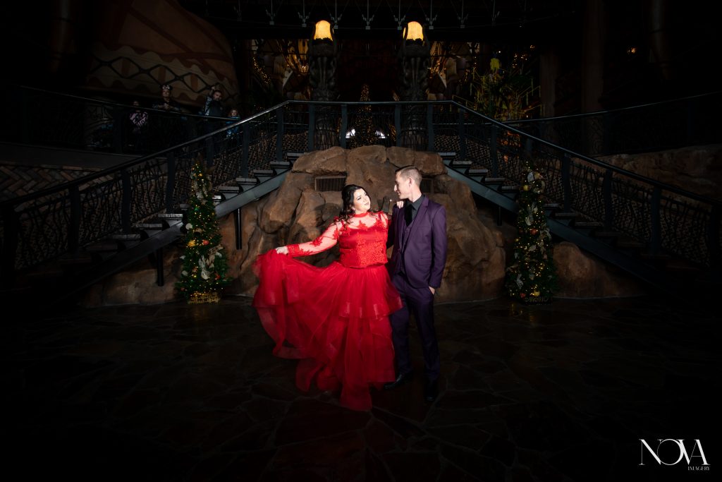 Couple posing in front of staircase for their Animal Kingdom Lodge photo session.
