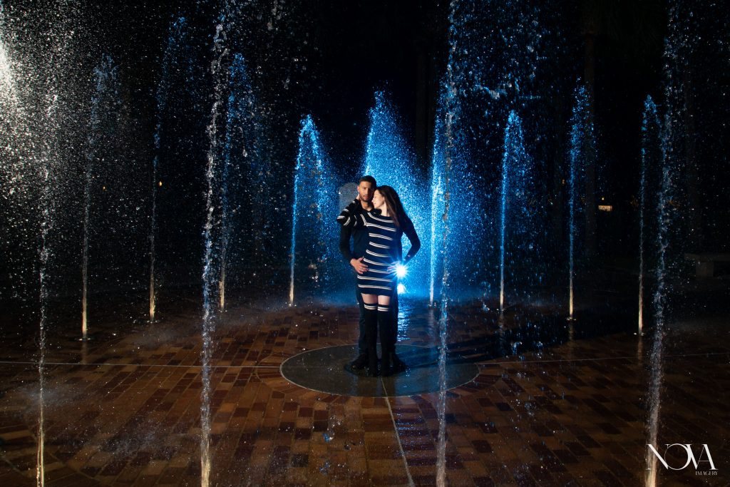 Couple in splash pad during their Downtown Winter Garden engagement session.