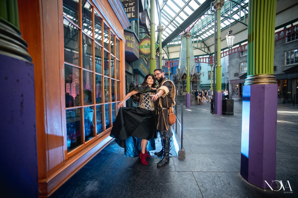 Couple poses with their wand for their Universal Studios engagement session.