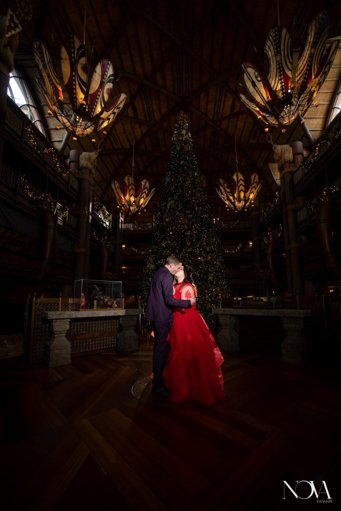 Kissing couple inside the lobby of Disney’s AKL during their portrait session.