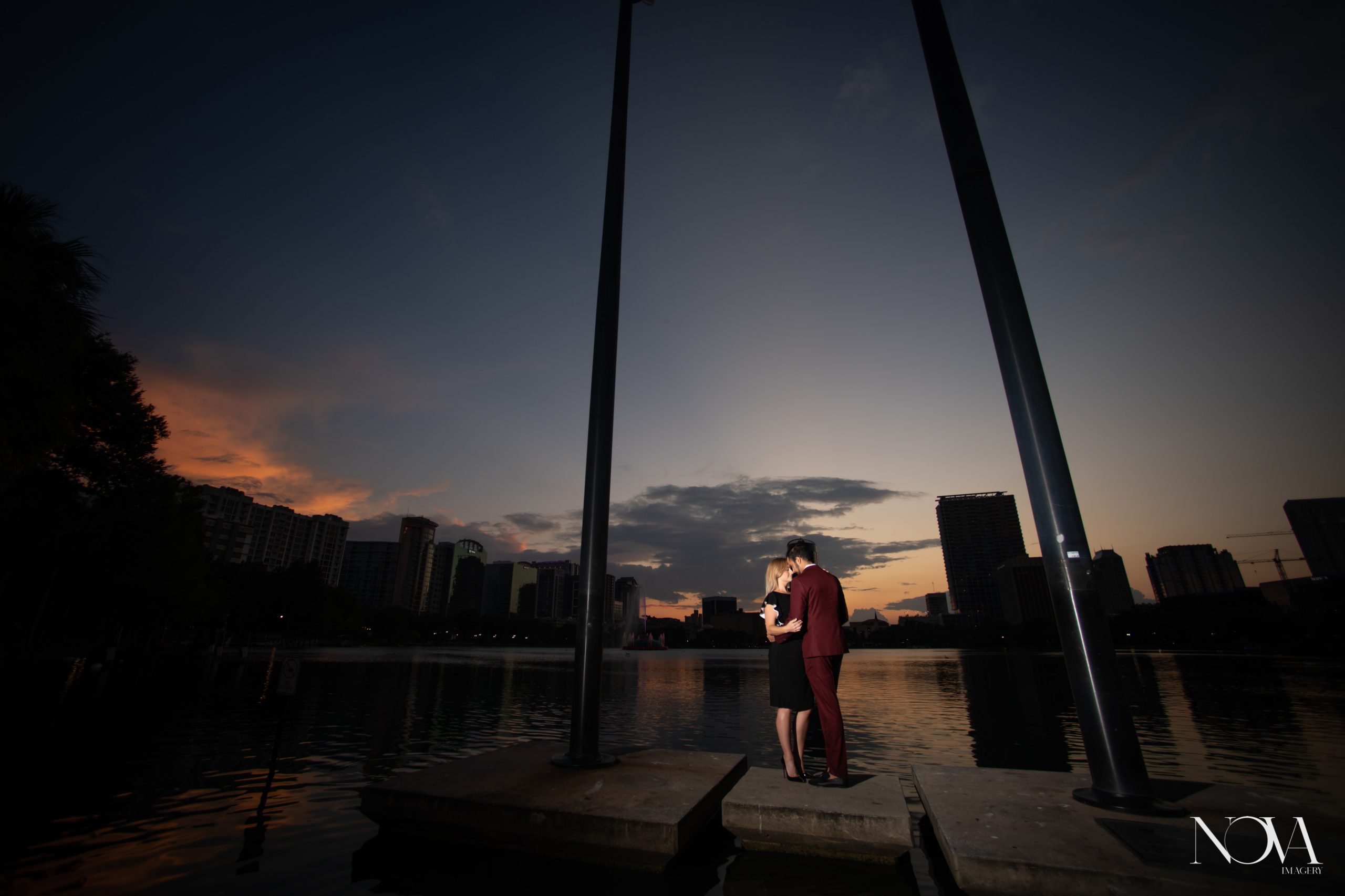 Couple hugging each other during their sunset Lake Eola engagement session.