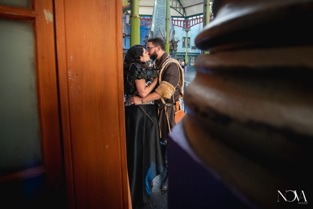 Couple kisses in Diagon Alley for their engagement photo session.