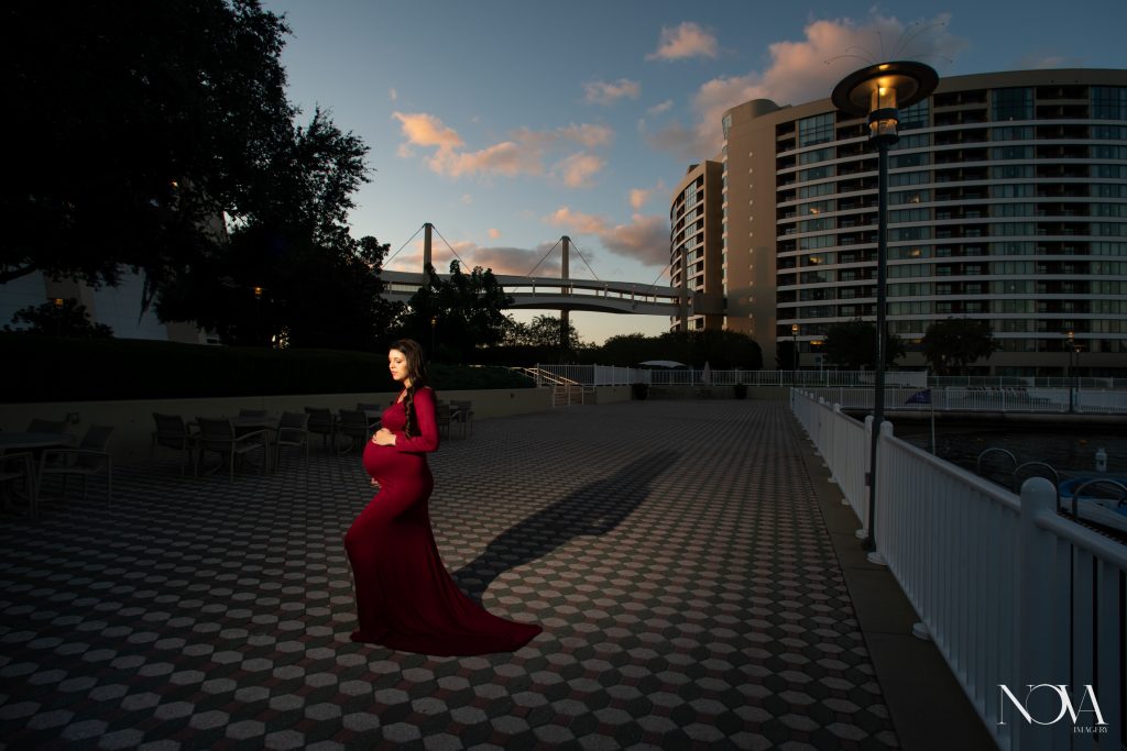 Mommy-to-be cradling pregnant belly during her maternity session at Disney’s Contemporary.