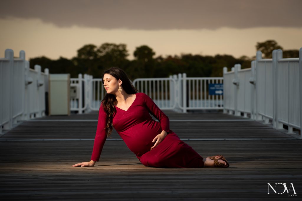 Pregnant mommy sitting on the dock during her maternity session at Disney’s Contemporary.