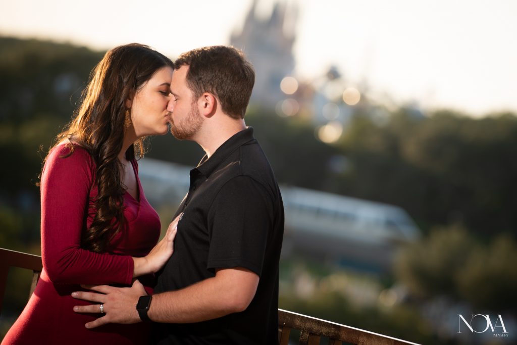 Parents-to-be kissing during their maternity session inside Disney’s Contemporary Resort.