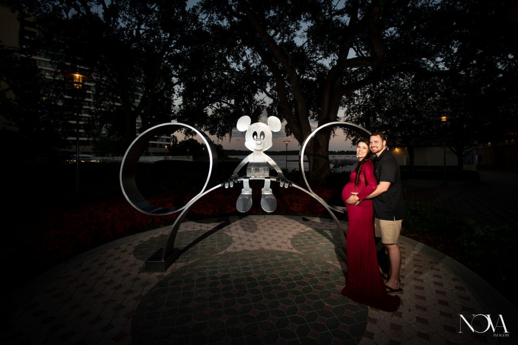 Parent-to-be posing in front of Mickey statue at Disney’s Contemporary during their maternity session.