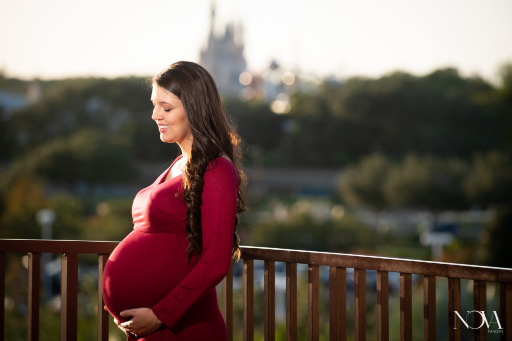 Mommy smiling at belly during her maternity session at Disney’s Contemporary Resort.