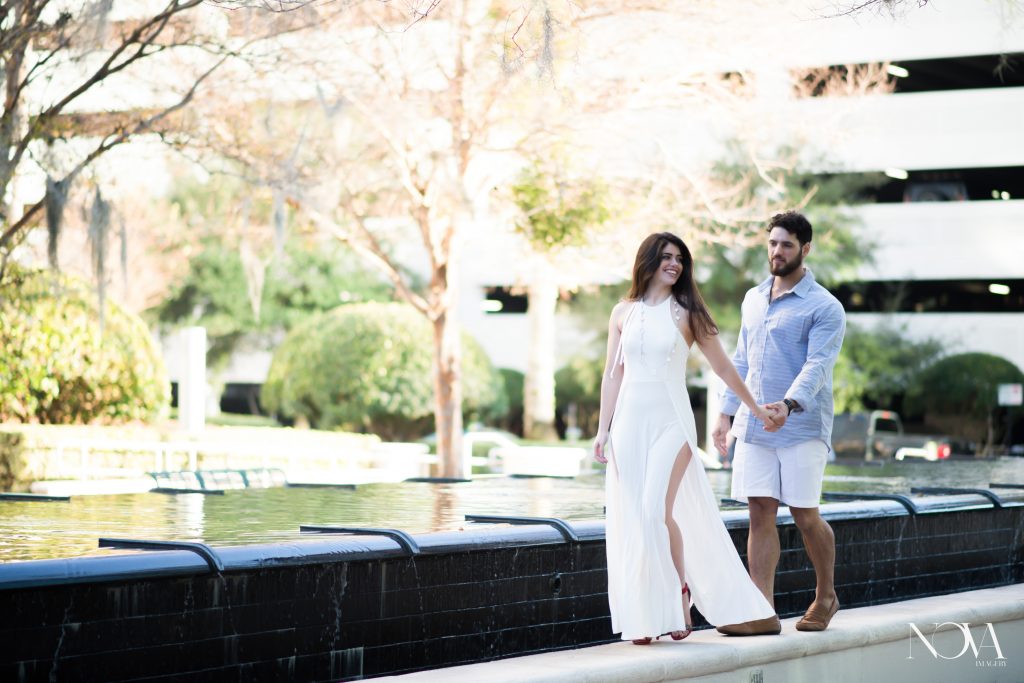 Couple candidly walking through Downtown Orlando for their engagement photos 