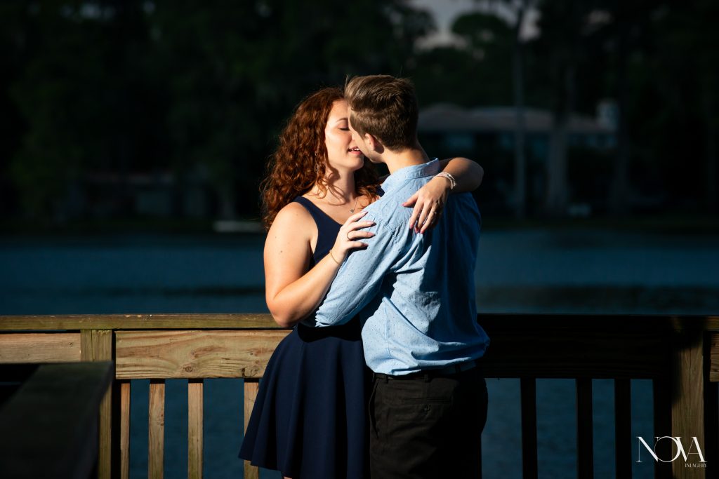 Engaged couple kissing on the dock, at Kraft Azalea Garden