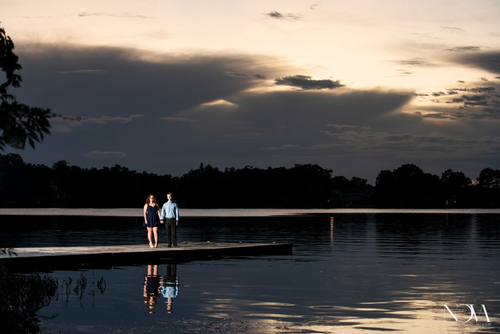 Couple holding hands on the dock during their engagement photos at Kraft Azalea Garden