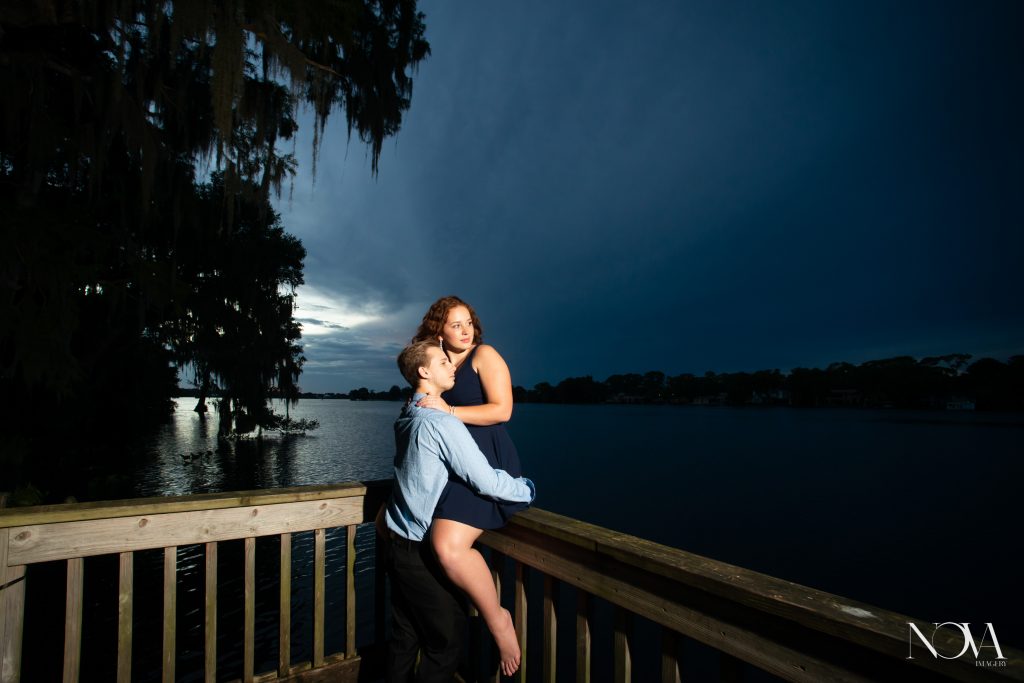Engaged couple enjoying lake view on the dock, at Kraft Azalea Garden