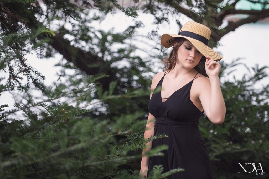 Caterina posing with a hat during her Lake Eola senior photoshoot.