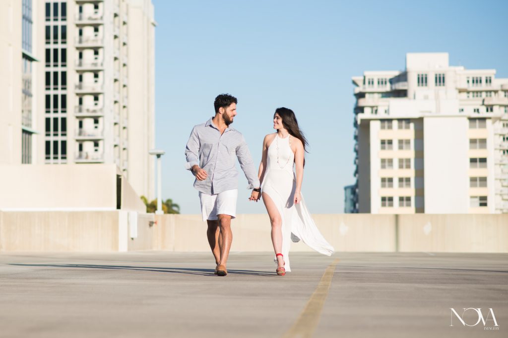 Couple walking hand in hand during their Downtown Orlando engagement session