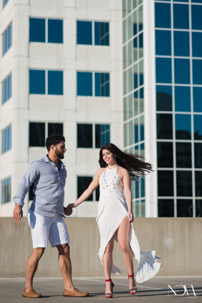 Couple dancing on Downtown Orlando rooftop for engagement photos.