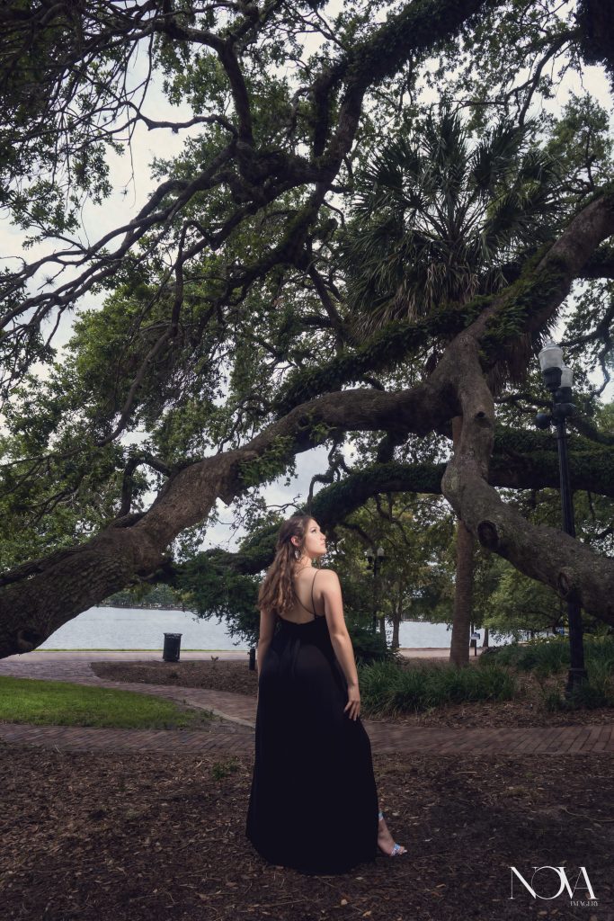 Caterina looking up towards the light during her Lake Eola senior photoshoot.