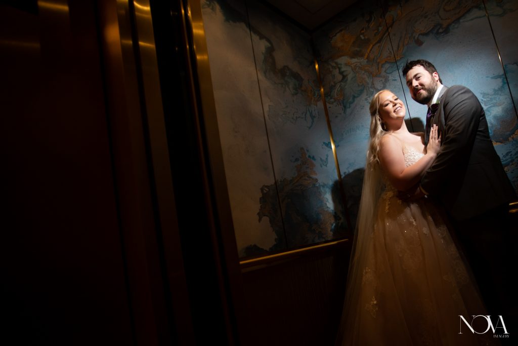 Bride and groom in elevator at WDW Swan and Dolphin.