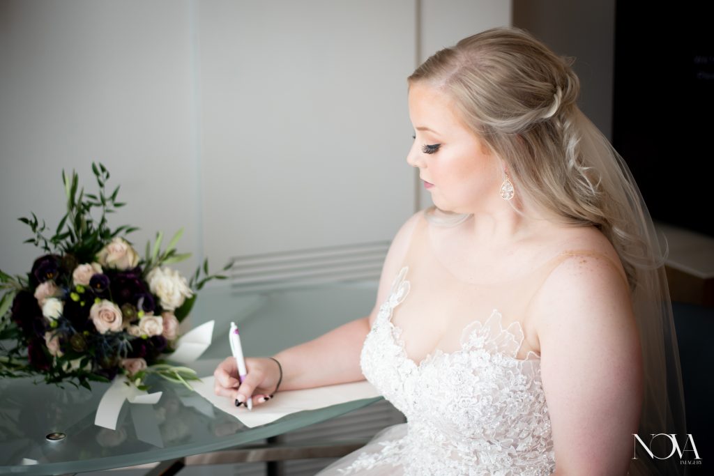 Bride writing vows for her wedding at WDW’s Swan and Dolphin Resort.