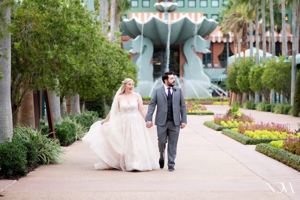 Bride and groom walking casually during wedding portraits at WDW Swan and Dolphin.