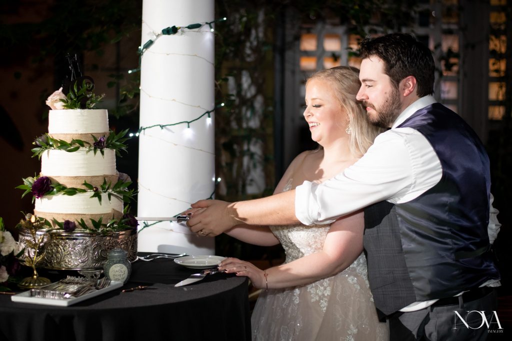 Bride and groom cutting their cake at their Swan and Dolphin wedding reception.