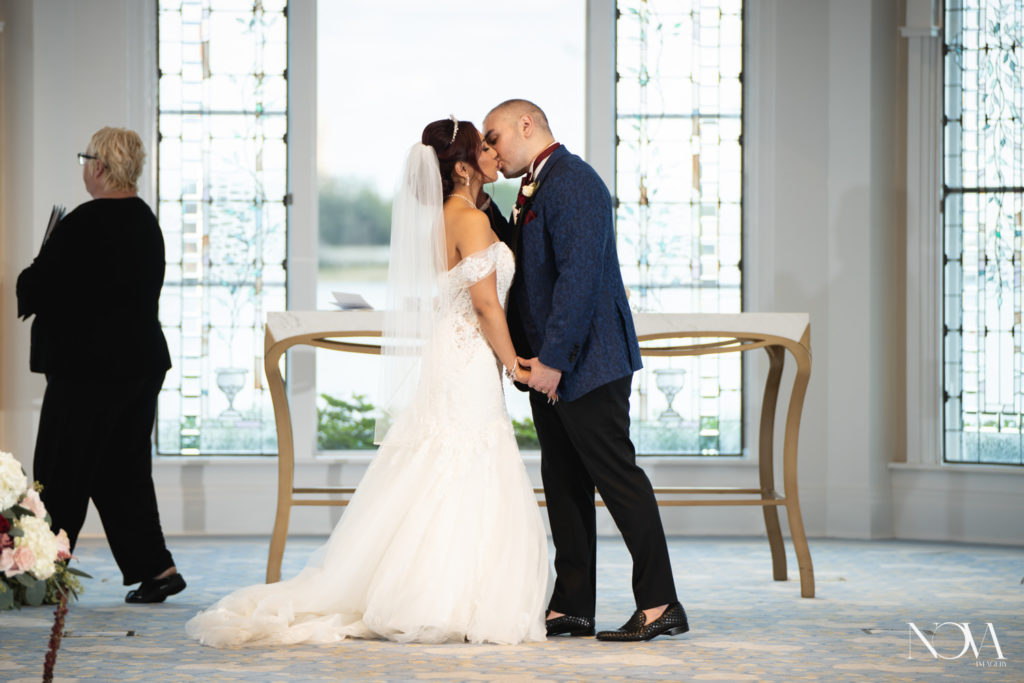 photography of bride and groom's first kiss at disney's wedding pavilion 