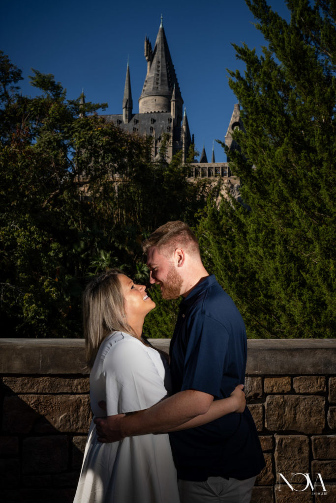 Hogwarts proposal photography with Castle behind couple