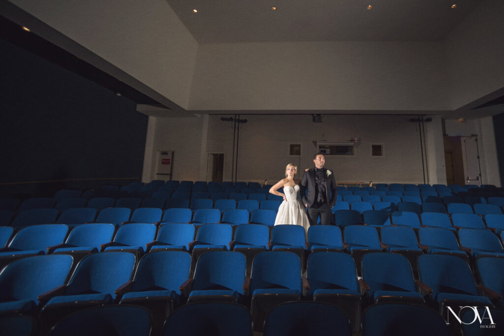 Bride and groom inside of the SunTrust auditorium at the Orlando Museum of Art wedding venue.