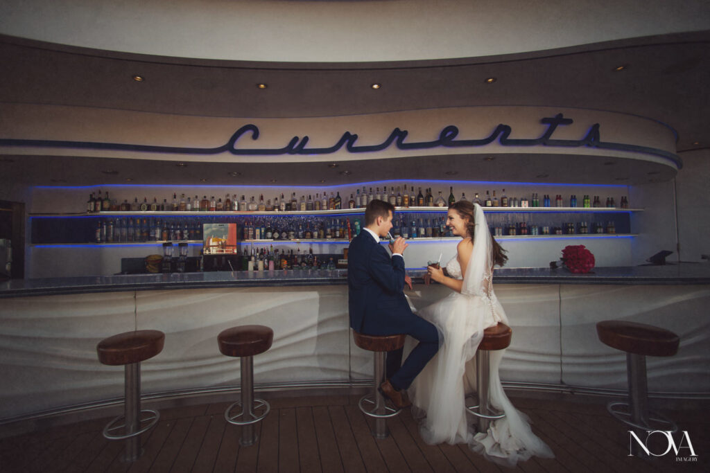 Disney cruise wedding photography on the dream, bride and groom having fun by the bar.
