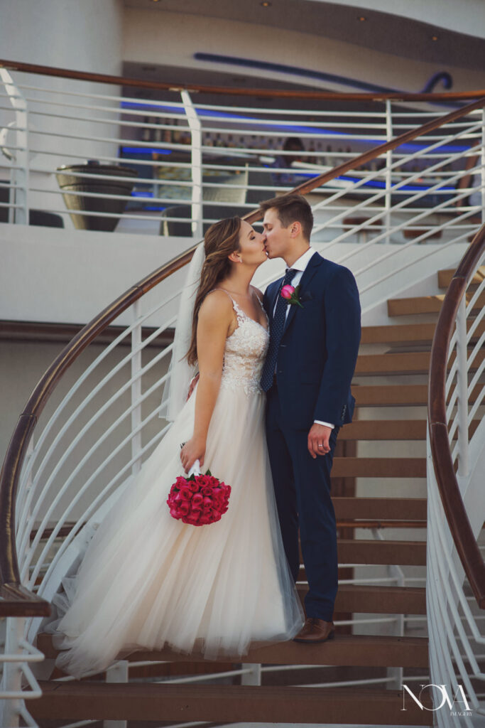 Bride and groom kissing after wedding ceremony aboard Disney Cruise Line ship.