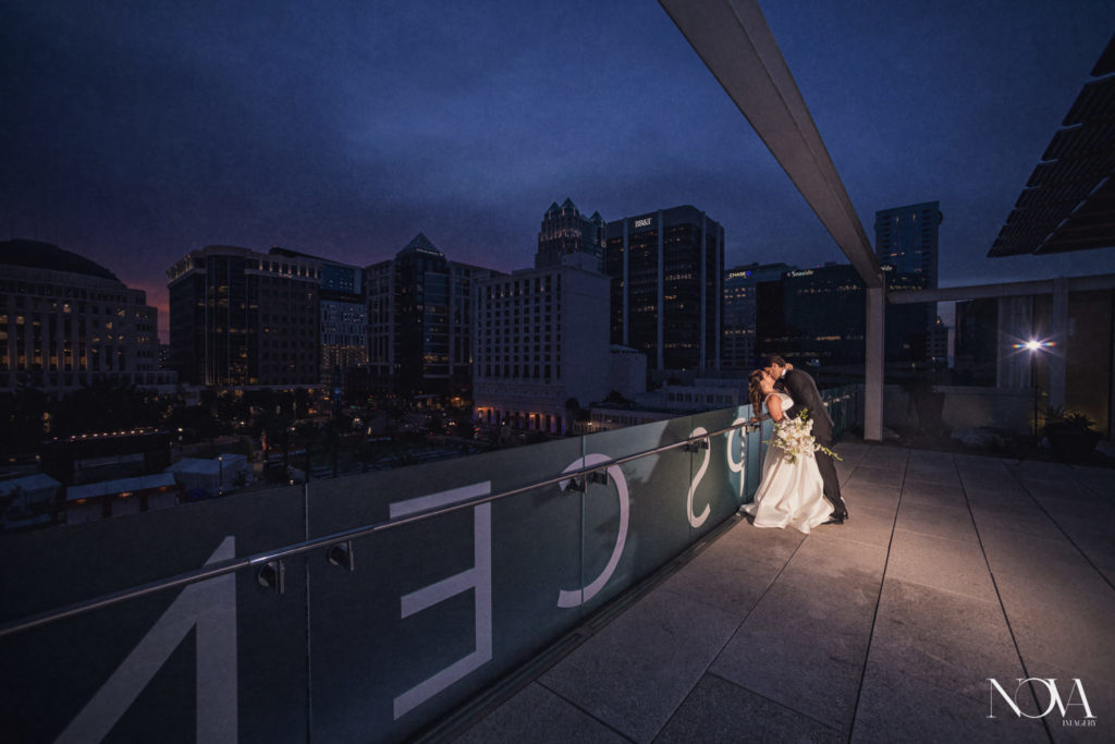 Nova Imagery captures bride and groom kissing at Dr Phillips Center during sunset.