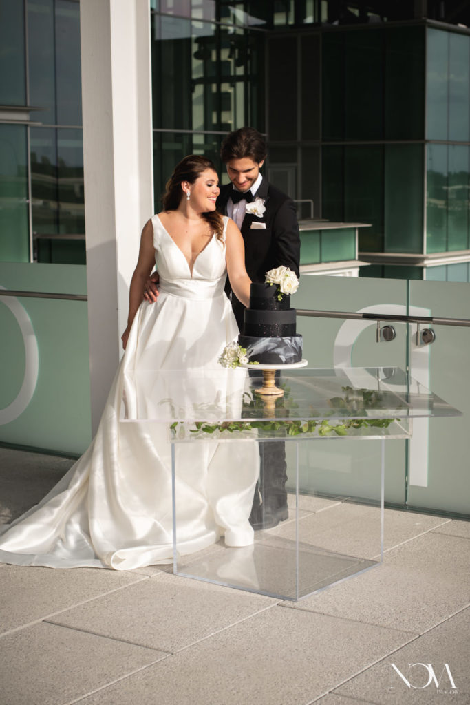 Bride and groom cut their wedding cake at Dr Phillips Center.