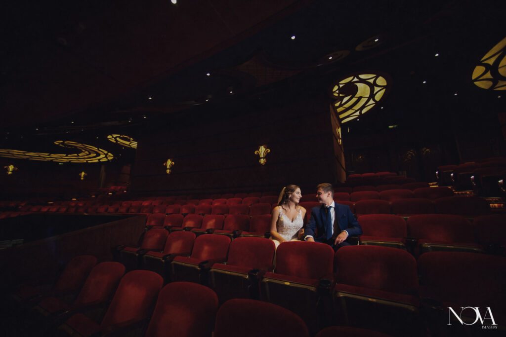 Bride and groom inside the Walt Disney Theater for their DCL wedding photography.