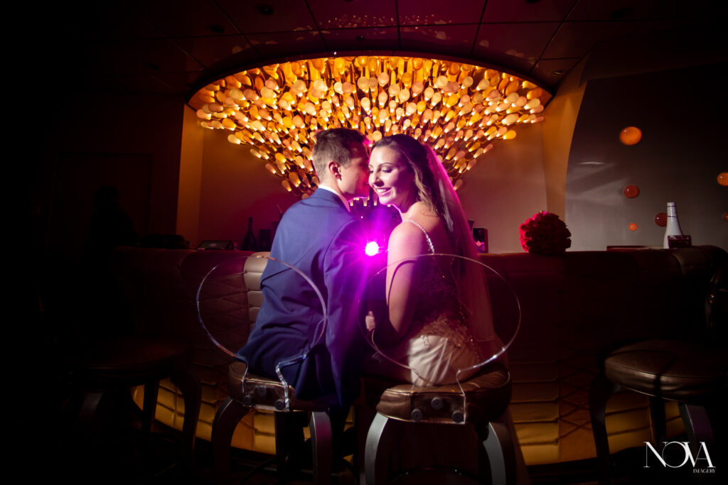 DCL wedding photography of bride and groom inside the Pink Lounge on the Dream ship.