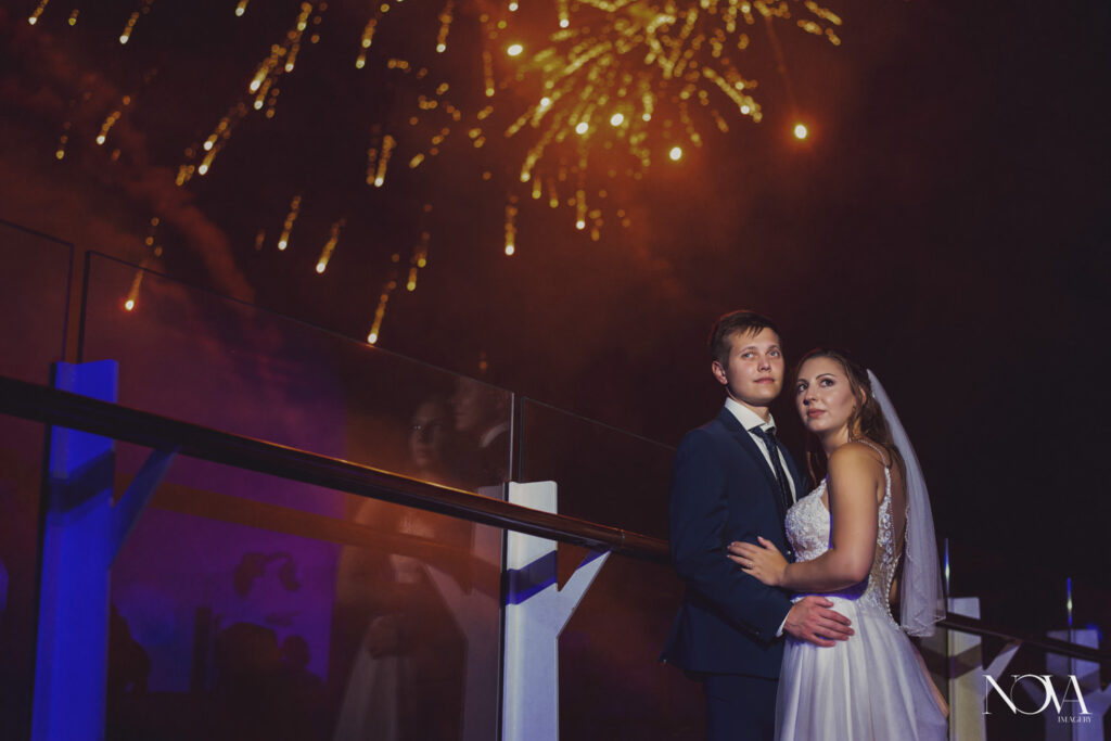 Bride and groom stand by fireworks for their DCL wedding photography.