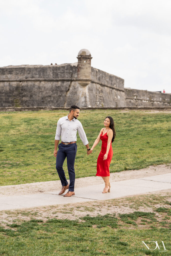 Walking couple in front of St Augustine fort.